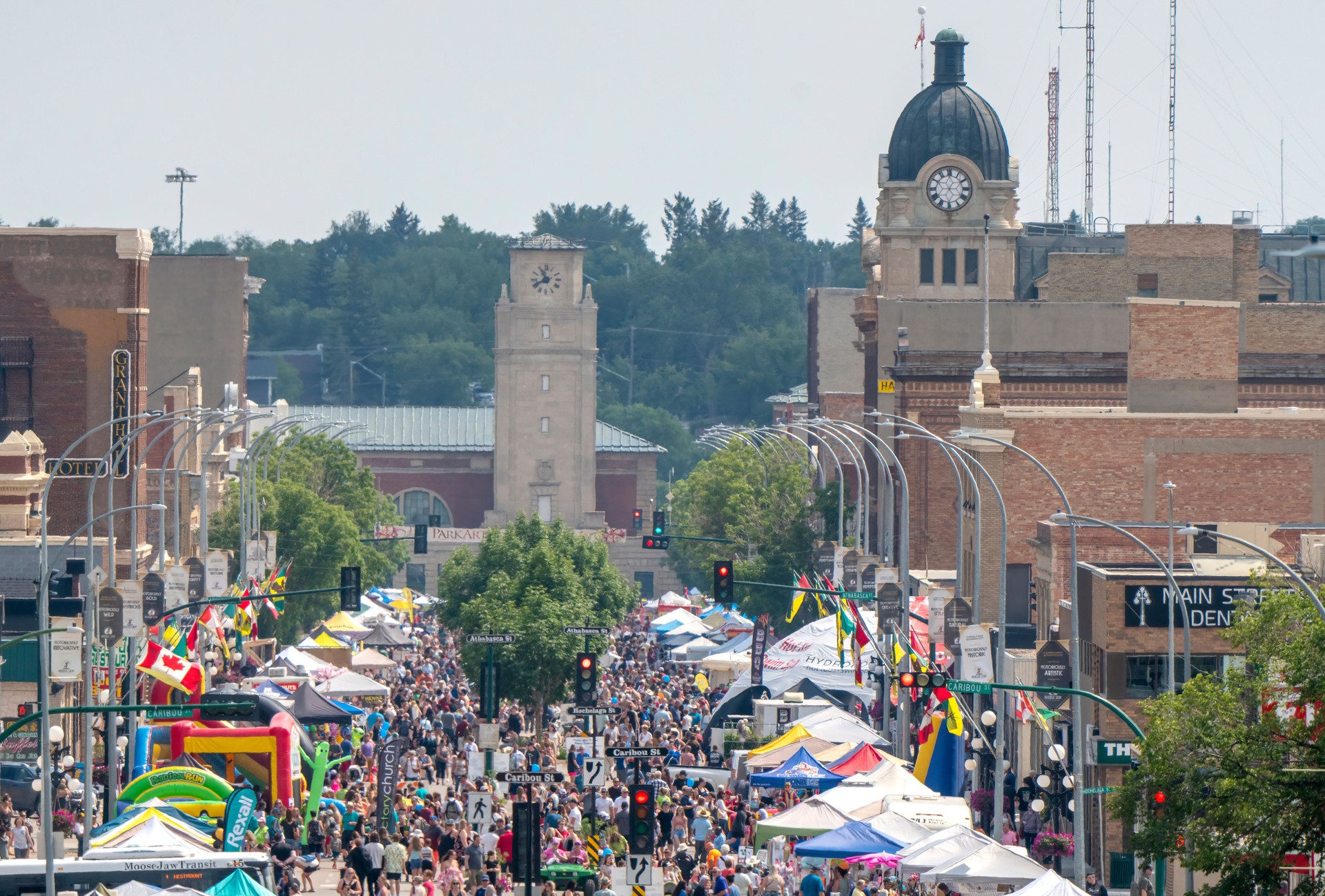 Crowd enjoying summer festival along main street in a small town
