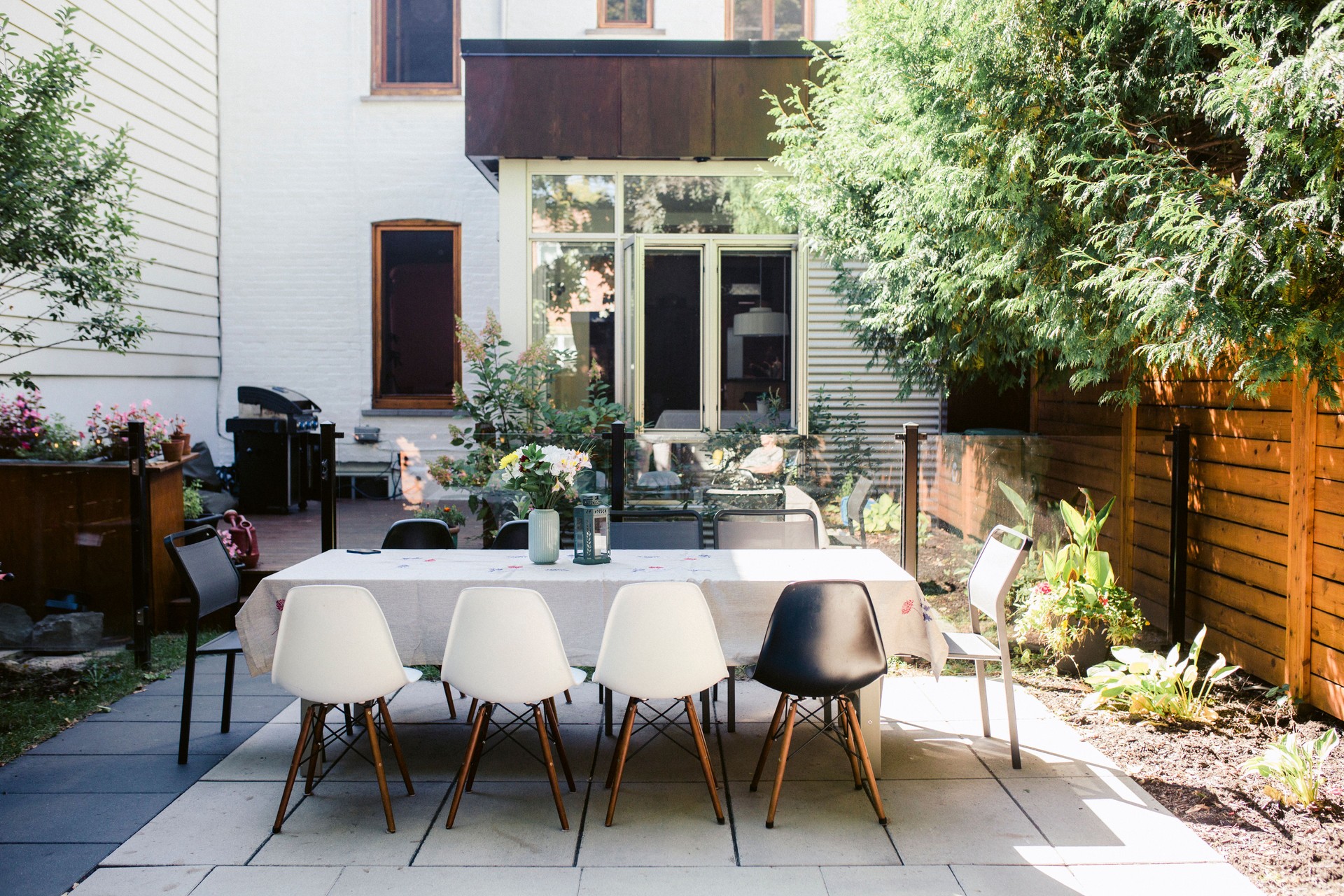 A large table set for dinner in a small courtyard